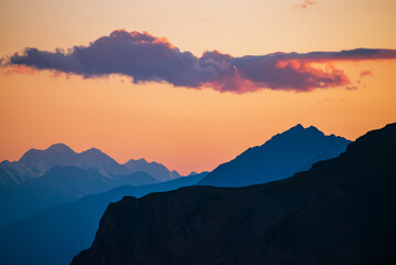 Wall Mural - colorful dawn landscape with beautiful mountains silhouettes and golden gradient sky with lilac clou