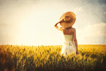 Sticker - Blode woman in hat with suitcase in wheat field in sunset time