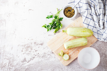 Sticker - Fresh zucchini on a wooden board with a knife