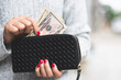 © methaphum - woman person holding a wallet in the hand of a  take money out of pocket.