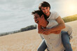 © kevin - a woman on the back of a man having fun in a wheat field