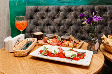 Wall Mural - Caprese salad and set of appetizers, toned