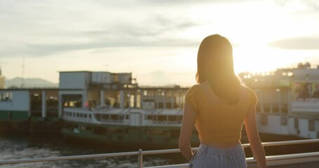 Canvas Print - Woman look at the city view at sunset time