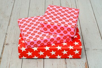 Poster - Closeup shot of three gift boxes stacked on top of each other on a wooden surface