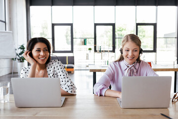 Poster - happy operators in headsets smiling while working in office