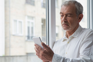 Wall Mural - mature man using mobile phone