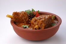 Mutton Curry Or Lamb Curry,arranged In An Earthenware With White Background