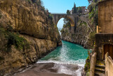 A turquoise sea rushes up the beach at Fiordo di Furore on the Amalfi Coast, Italy