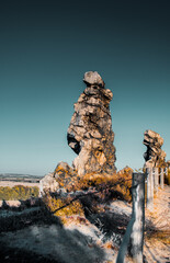 Wall Mural - Giant sand stone rock stacks in the countryside landscape on a sunset sunny day with colorful and beautiful light. Exploring german nature places. Harz Mountains, Harz National Park in Germany.