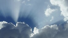 Sun Rays From A White Cloud. A Cloud Covers The Sun. Birds Fly Against The Blue Sky With Clouds. A Halo Of Sunlight On The Sky.