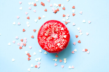 Wall Mural - Colored donuts with colorful sprinkles on blue background. Donut day concept. Close-up