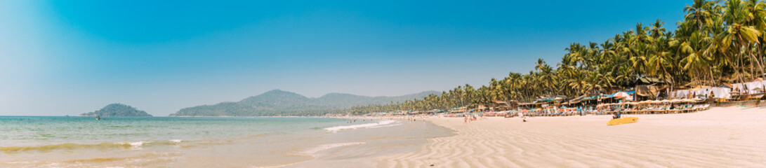 Canacona, Goa, India. Sunny Sky Over Calm Water Of Arabian Sea. Natural Landscape With Sandy Palolem Beach At Sunny Summer Day With Blue Sky