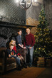 © Tsakno - A family with two sons in a new year or Christmas interior