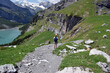 Hiker admiring the stunning panorama  around Oeschinen Lake in Switzerland