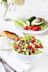 Wall Mural - Salad with strawberries, quinoa, avocado, cucumber, lettuce, onions and green peas. vegetarian food.copy space