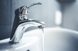 Water tap , faucet. Flow water in bathroom with sink. Modern clean hause. Backround hygiene.