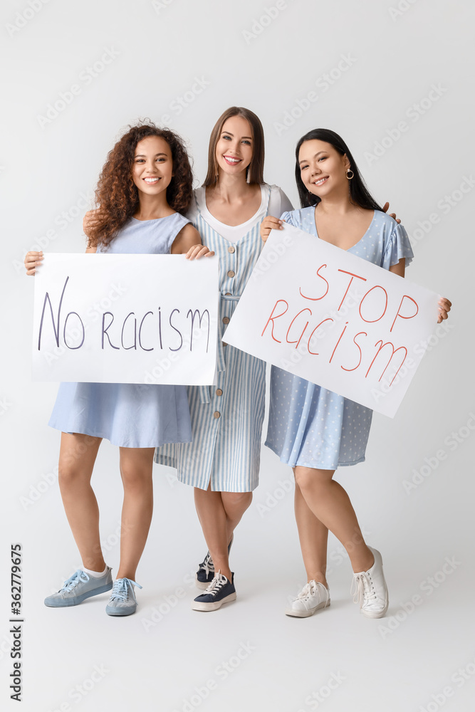 Women of different nationalities with placards on white background. Stop racism