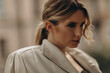 © Tasha Sinchuk - Fashionable portrait of a stylish blonde woman in elegant totall beige look leather trench coat and smoky eyes makeup in the outdoor. Spring - autumn fashion concept. Soft selective focus.