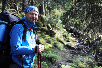 Active healthy man hiking in beautiful forest