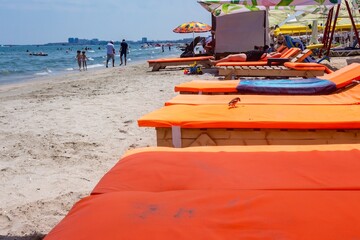 Sticker - Beautiful shot of an orange sheet Sun Bed in Rimini beach Italy