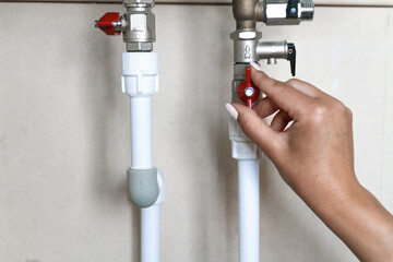 Woman's hand closes the valve. Saving Water Consumption Concept