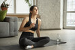 © master1305 - Concentrated. Sporty arabian, muslim beautiful young woman taking professional yoga lessons online and practice at home. Concept of healthy lifestyle, wellness, wellbeing, hobby. Flexible and