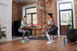 © Yakobchuk Olena - Charming ladies performing sport activities at home