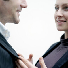 Wall Mural - Businesswoman holding businessman's suit