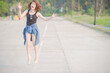 Happy Young Woman Jumping On Road