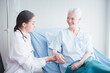 © nuttawutnuy - Happy Elderly patient talk with woman doctor at room in hospital. Healthcare homecare concept