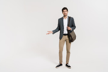 Poster - Photo of pleased businessman holding copyspace while posing with bag