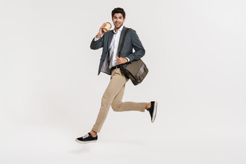 Poster - Photo of cheerful businessman drinking coffee while running with bag