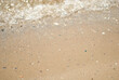 © Kristina - Sea sand and waves with sun flare.