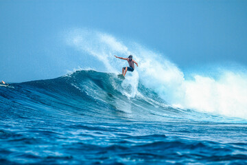 surfer on perfect blue aquamarine wave, empty line up, perfect for surfing, clean water, indian ocea