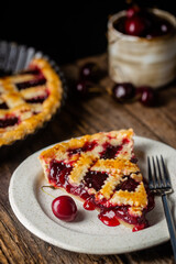 Wall Mural - piece of Delicious homemade classic cherry pie with a flaky crust on dark rustic background