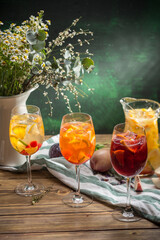 Wall Mural - Delicious summer lemonades with ice, strawberry, peach and lime Three glasses with of cocktail on wooden table