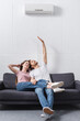 © LIGHTFIELD STUDIOS - young happy couple at home with air conditioner