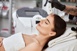woman in spa getting theraphy with special machine on forehead by beautician
