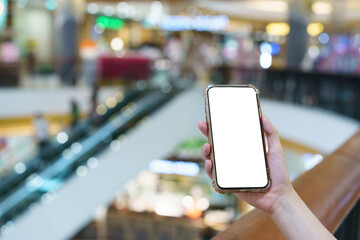 Wall Mural - Mockup, hands holding blank white screen mobile phone in blurred department store, digital payment concept