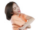 © marchsirawit - woman taking off her orange shirt, side view. White background.