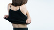 © marchsirawit - woman taking off her black shirt, back view. White background.