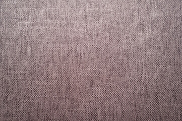 close view of a grey rustic fabric texture. to use as background. Taken indoors under a bright white light