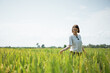 © Odua Images - Young girl walking in the middle of the rice field with exotic view in the bright sunny day