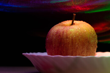 Wall Mural - Wet apple with a abstract background .