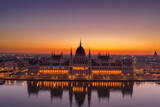Fototapeta Paryż - Aerial drone shot of Hungarian Parliament lights off before sunrise in Budapest dawn