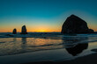 © J Huser Photography - Orange sunset glows behind Haystack Rock on Cannon Beach in Oregon
