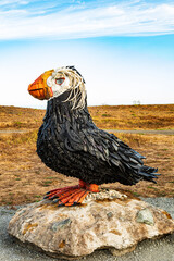 Wall Mural - Vertical Image - Tufted Puffin sculpture made of plastic trash that's washed up on beaches near Bandon Oregon