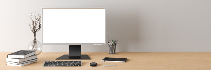 Workspace with blank computer monitor white screen mockup on the wooden desk near white wall.