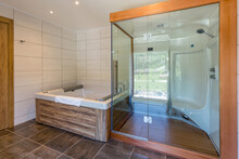 Interior Of Luxury Hotel Bathroom With Hydromassage Bathtub And Shower Cabin