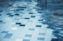A Tiled Bottom Surface Of A Street Pool With Water Of Classic Blue Color, With Some Tiles Of A Different Tone And A Diagonal Shadow On The Right; Shallow Depth Of Field, Selective Focus In The Middle